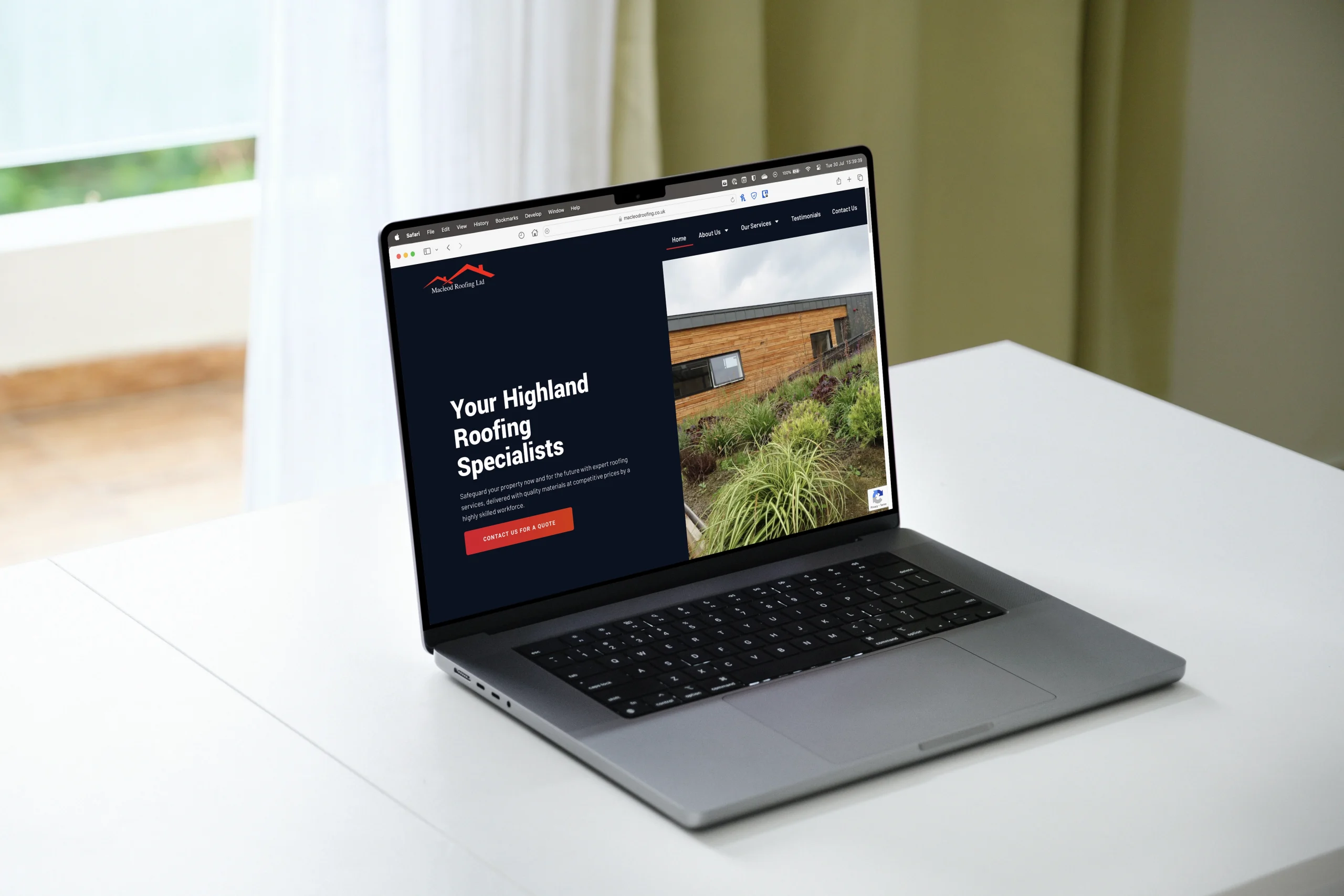 A laptop on a white table displays a landing page for Highland Roofing Specialists, featuring a house with a wooden facade and greenery.